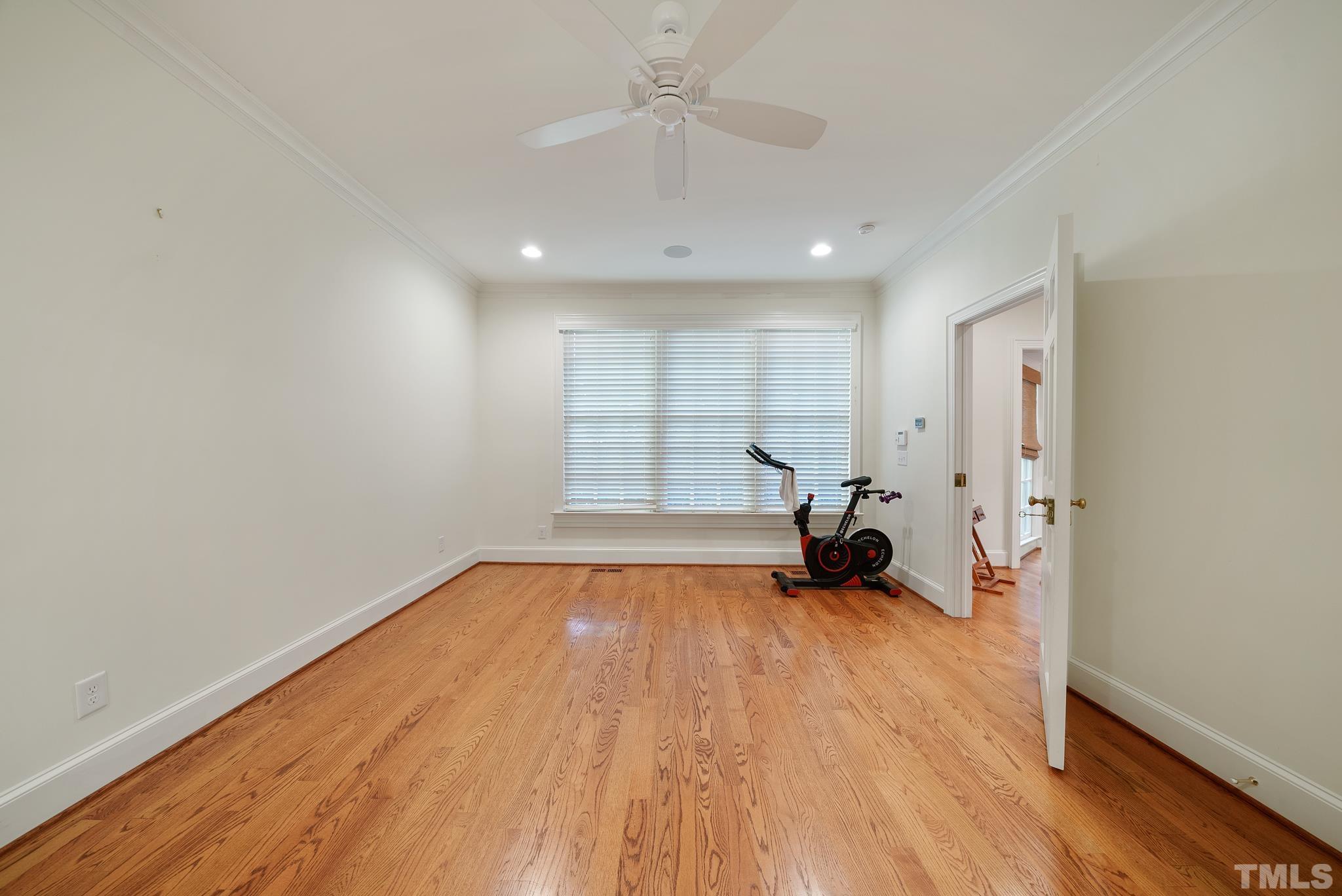 204 Queensferry Road Cary, NC 27511 - Photo 13 of 41 a view of empty room with wooden floor and fan