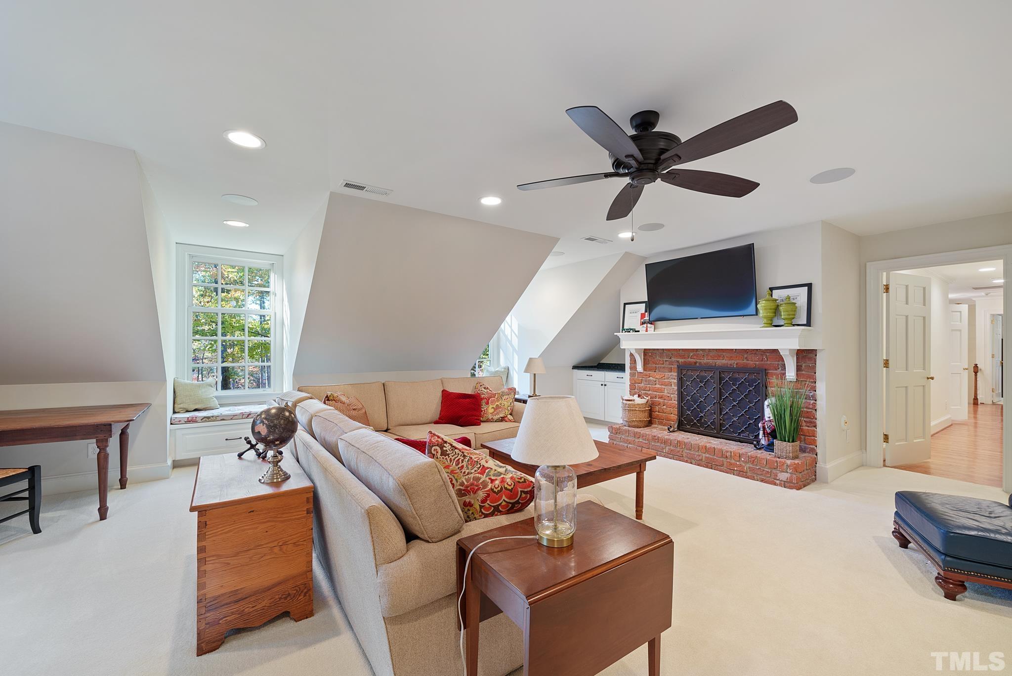204 Queensferry Road Cary, NC 27511 - Photo 17 of 41 a living room with furniture a fireplace and a large window
