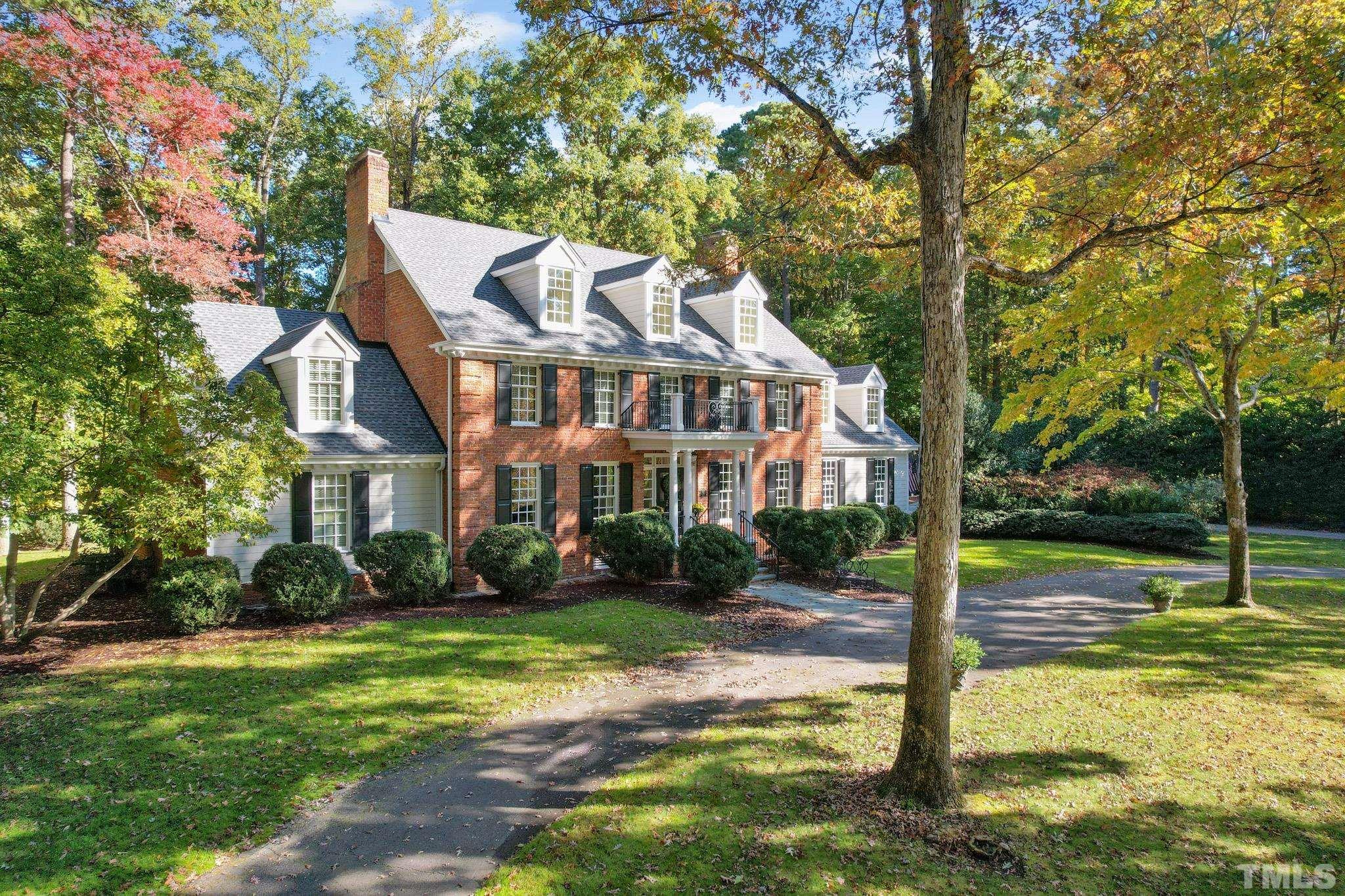 204 Queensferry Road Cary, NC 27511 - Photo 34 of 41 a view of a white house next to a yard with big trees