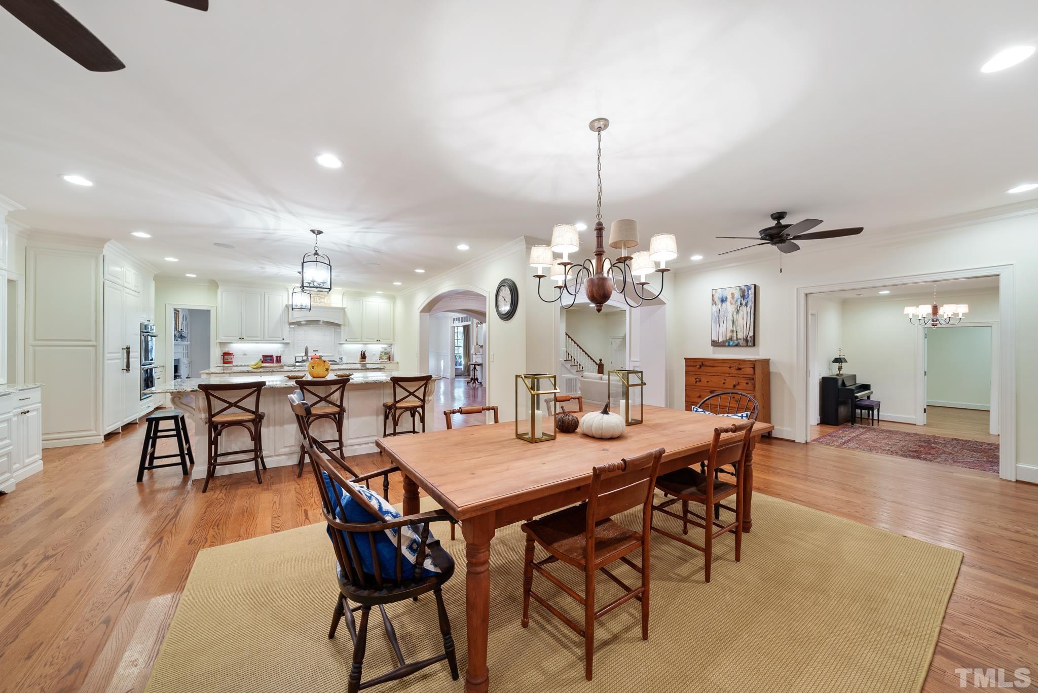 204 Queensferry Road Cary, NC 27511 - Photo 6 of 41 a view of a dining room and livingroom with furniture wooden floor a chandelier