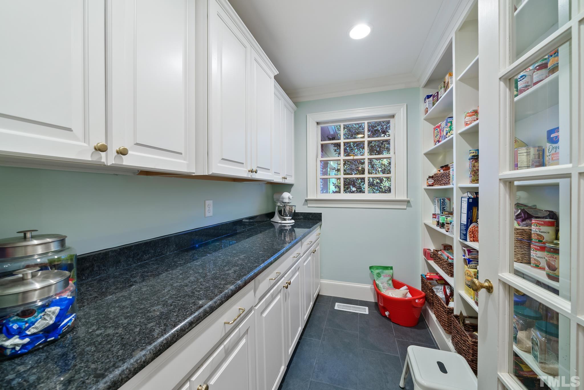 204 Queensferry Road Cary, NC 27511 - Photo 8 of 41 a kitchen with granite countertop lots of clutter and stainless steel appliances