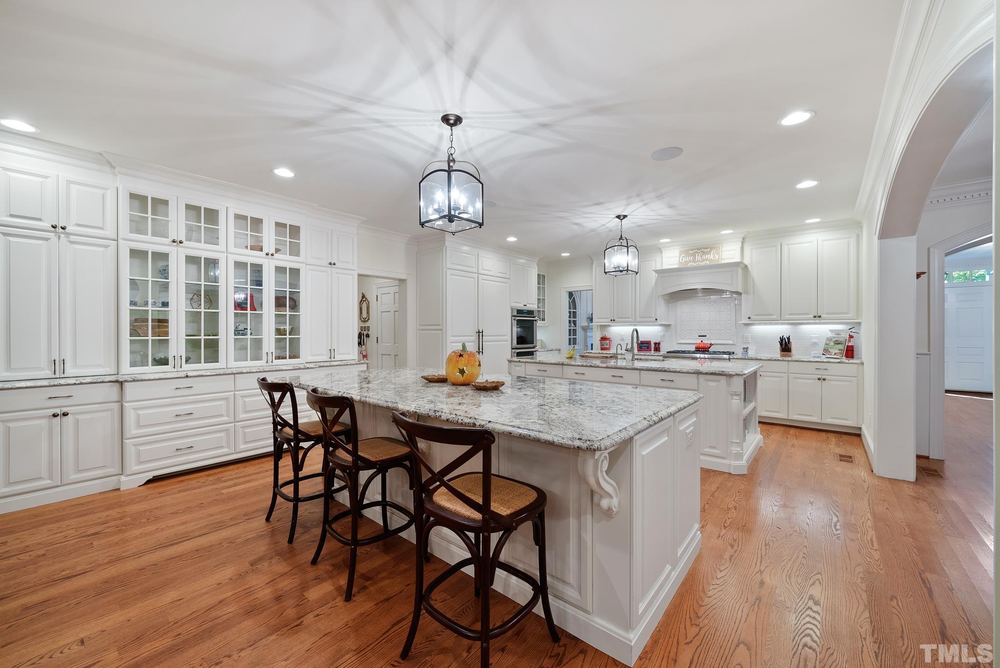 204 Queensferry Road Cary, NC 27511 - Photo 9 of 41 an open kitchen with kitchen island and stainless steel appliances