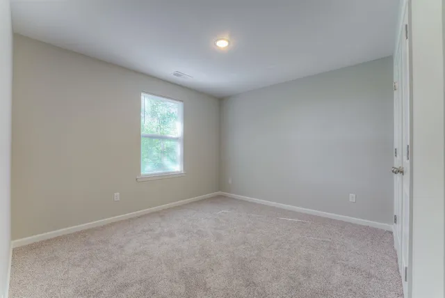a view of an empty room and closet area