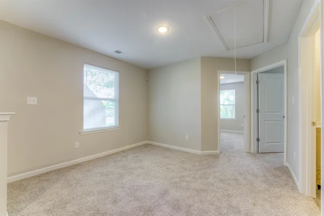 a view of an empty room and closet area