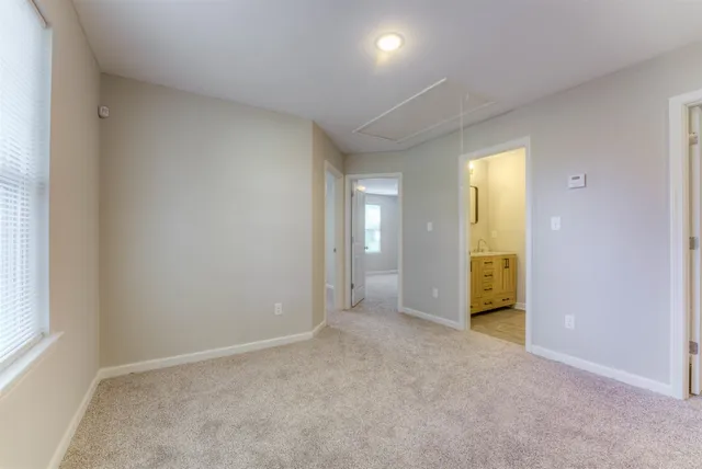 a bathroom with a double vanity sink mirror and bathtub