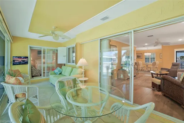 a living room with furniture and a floor to ceiling window