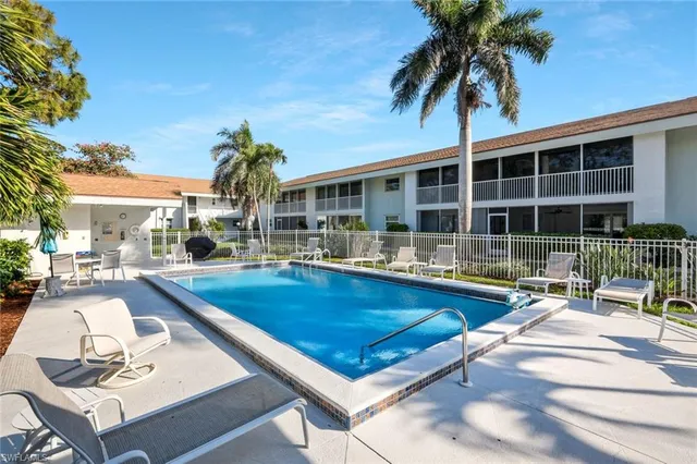a view of a house with swimming pool and sitting area