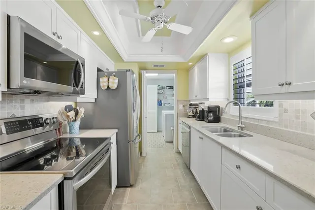 a kitchen with a sink stainless steel appliances and cabinets