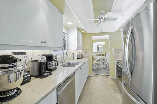 a kitchen with a sink appliances and cabinets
