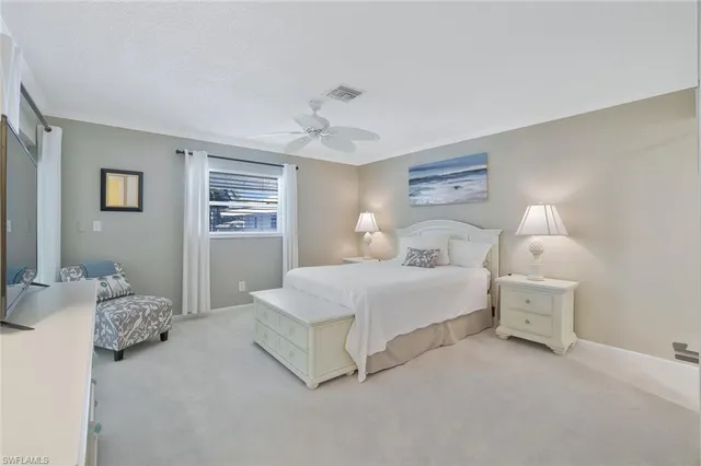 a bedroom with a bed and a lamp