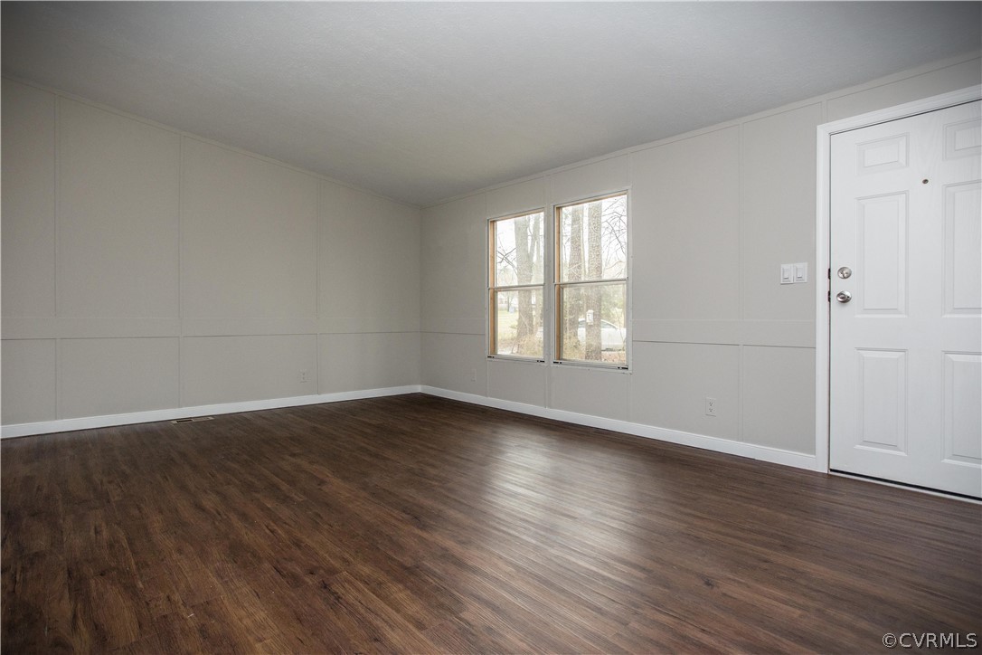 17208 Hamilton Arms Road Dewitt, VA 23840 - Photo 8 of 14 an empty room with wooden floor and windows