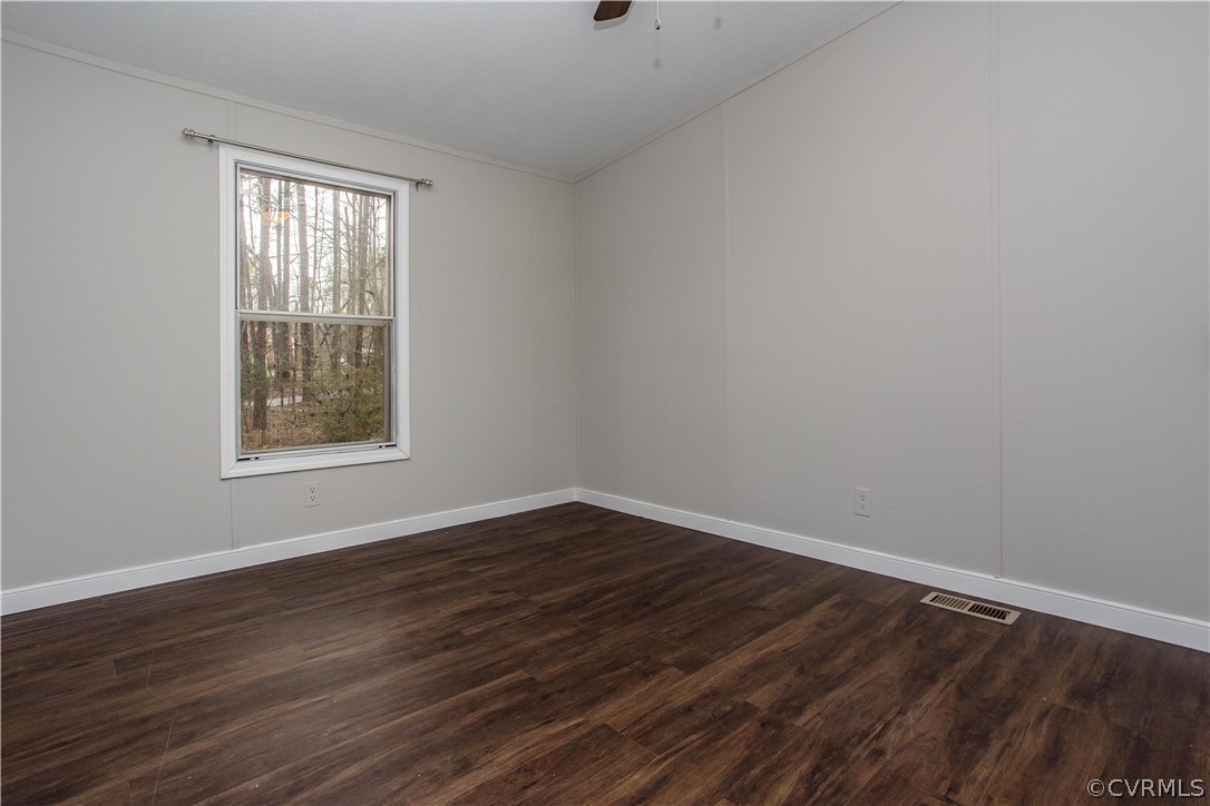 17208 Hamilton Arms Road Dewitt, VA 23840 - Photo 10 of 14 a view of an empty room with wooden floor and a window