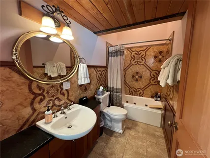 a bathroom with a toilet sink and mirror