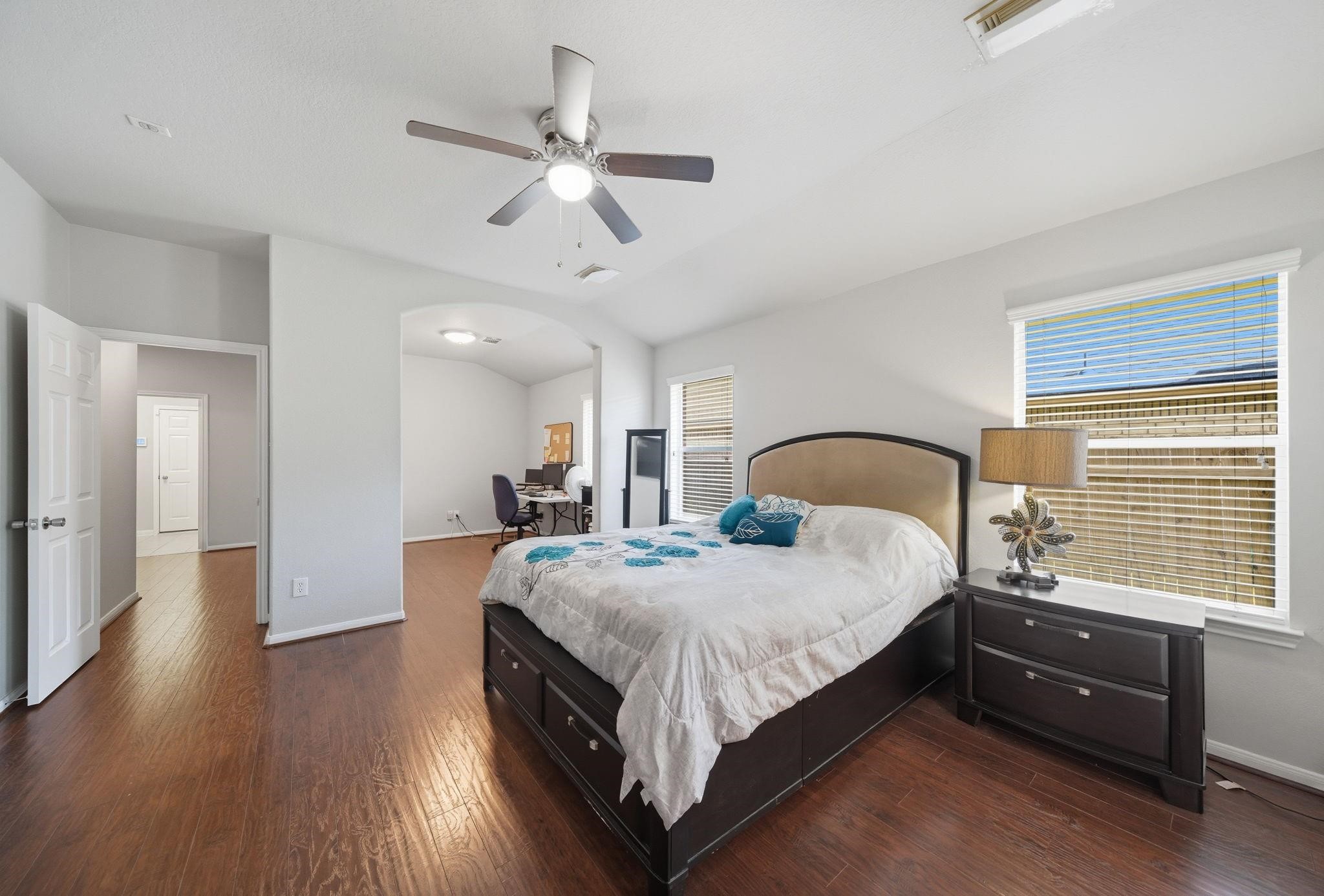 25707 Crisp Spring Lane Spring, TX 77373 - Photo 6 of 14 a bedroom with a bed and a chandelier