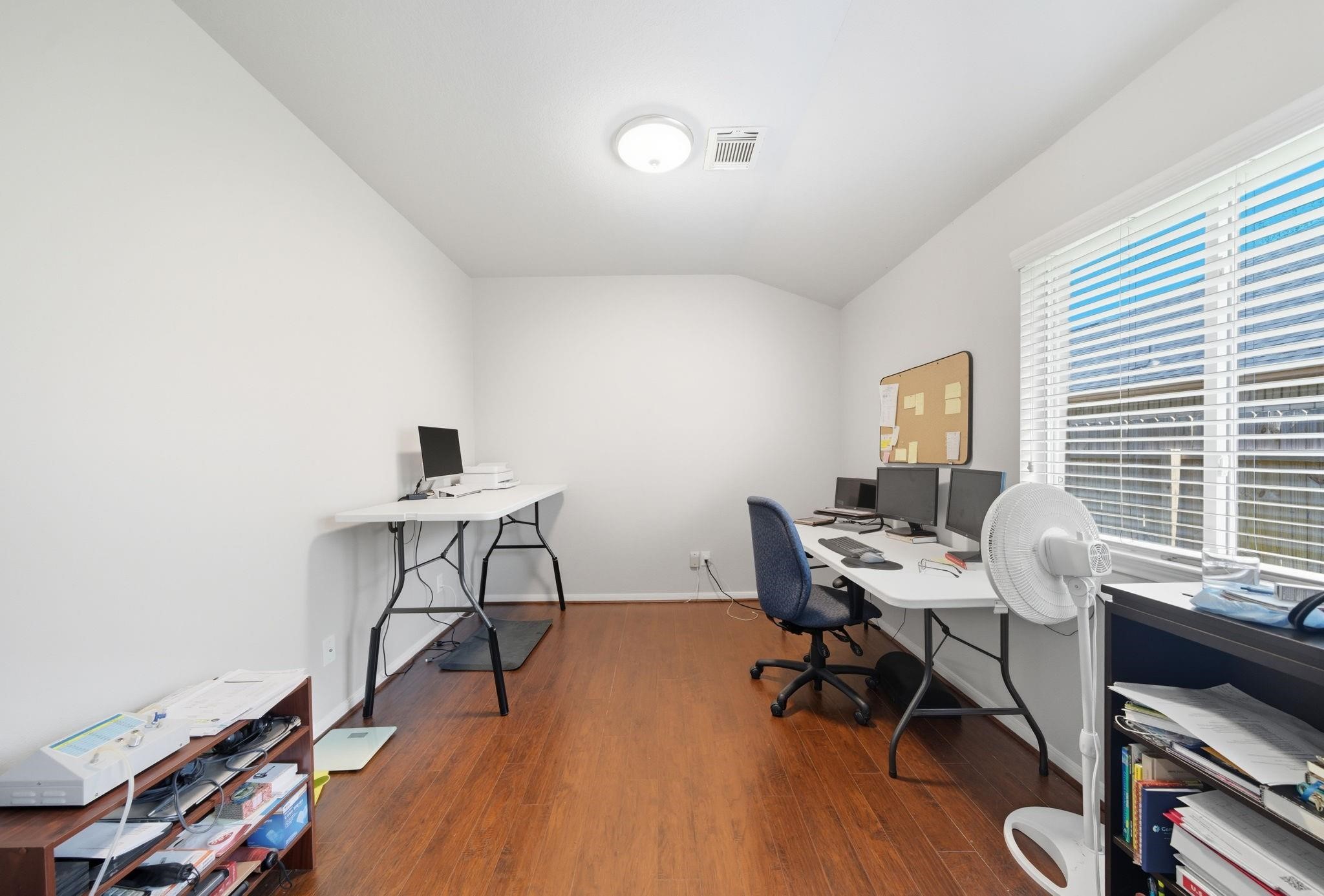 25707 Crisp Spring Lane Spring, TX 77373 - Photo 7 of 14 a view of a workspace with furniture and a window