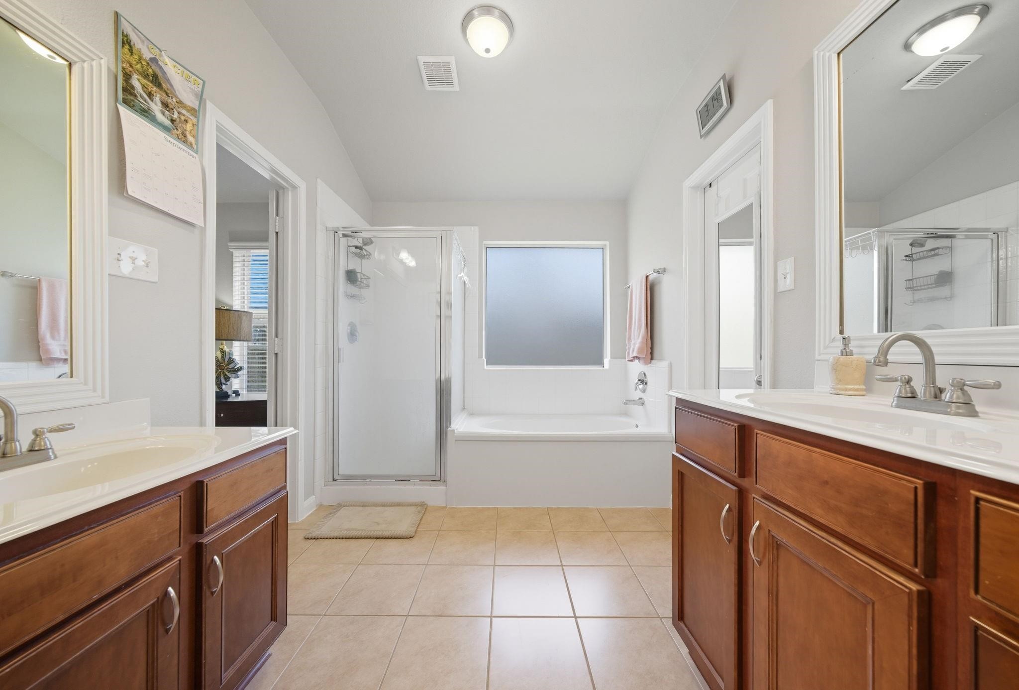 25707 Crisp Spring Lane Spring, TX 77373 - Photo 8 of 14 a spacious bathroom with a tub sink shower and mirror