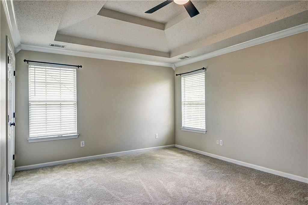 2415 Marsh Rabbit Bend Decatur, GA 30035 - Photo 14 of 18 an empty room with ceiling fan and windows