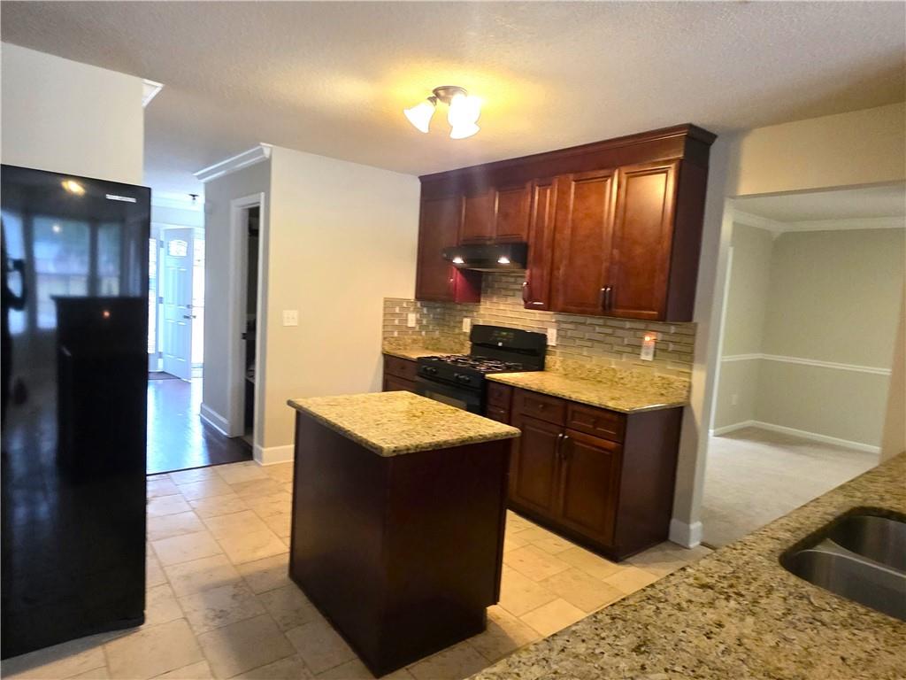 2415 Marsh Rabbit Bend Decatur, GA 30035 - Photo 3 of 18 a kitchen with stainless steel appliances granite countertop wooden cabinets a granite counter top and a stove