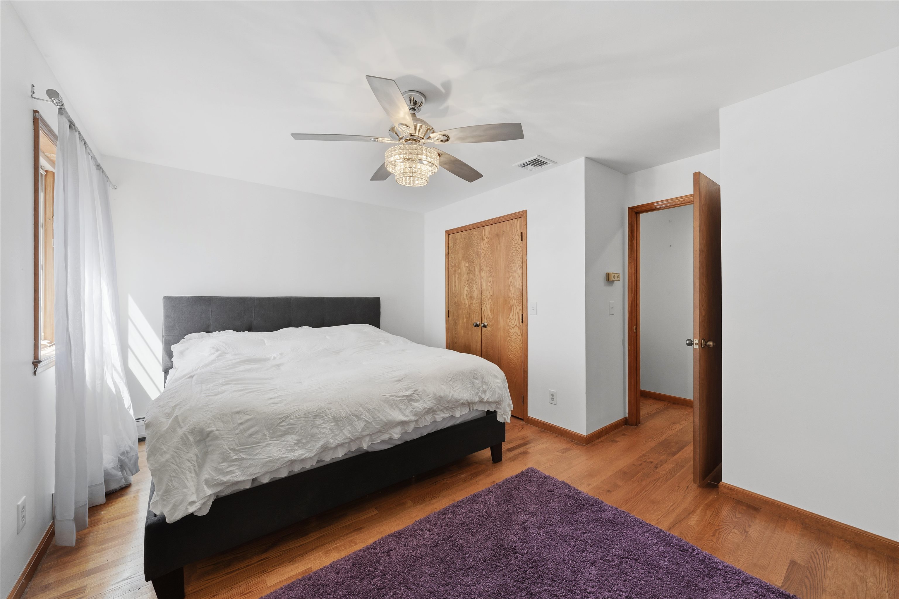2 Carol Road Butler, NJ 07405 - Photo 30 of 49 a bedroom with a bed and a chandelier