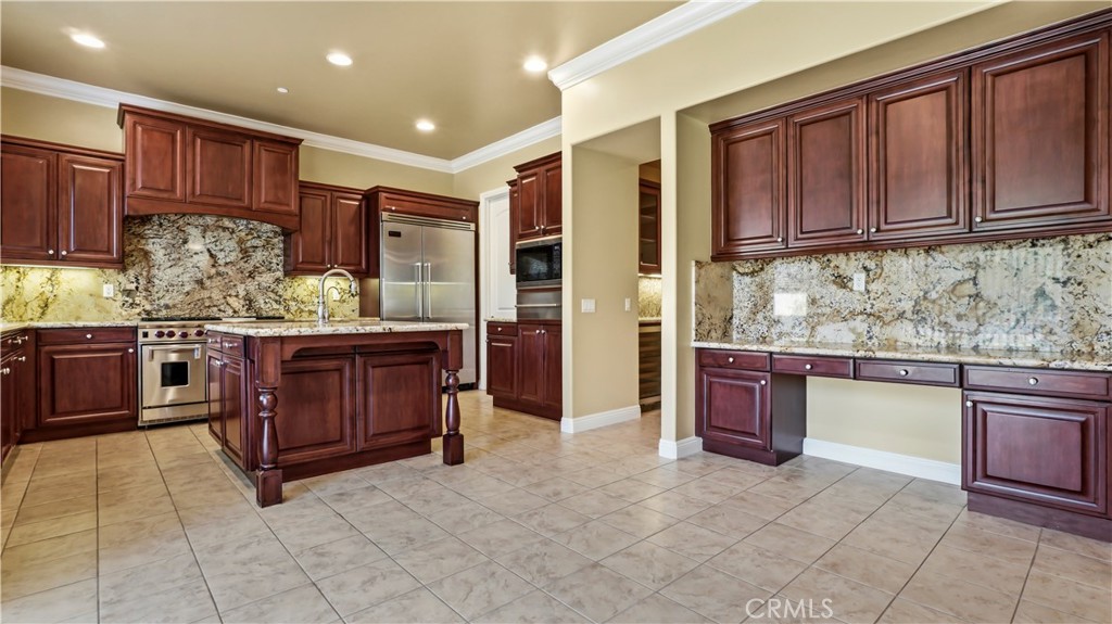 18549 Clydesdale Road Granada Hills, CA 91344 - Photo 15 of 56 a kitchen with stainless steel appliances granite countertop a stove and cabinets