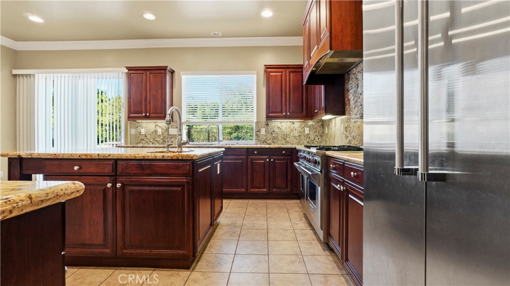 18549 Clydesdale Road Granada Hills, CA 91344 - Photo 16 of 56 a kitchen with a sink stove and cabinets