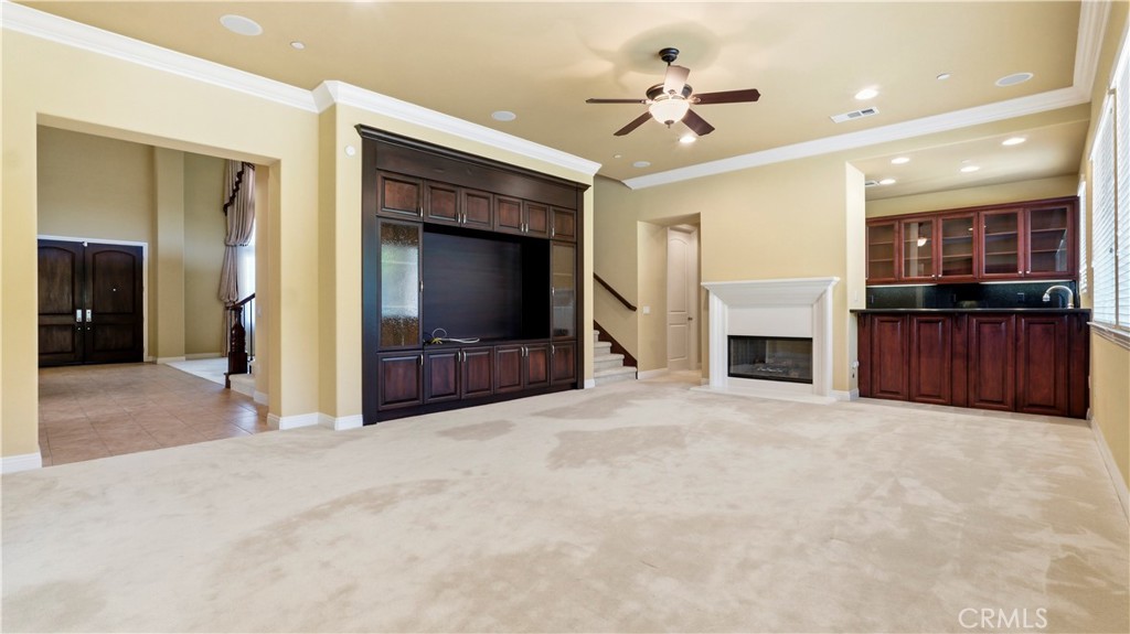 18549 Clydesdale Road Granada Hills, CA 91344 - Photo 19 of 56 a view of an empty room with a fireplace and a kitchen