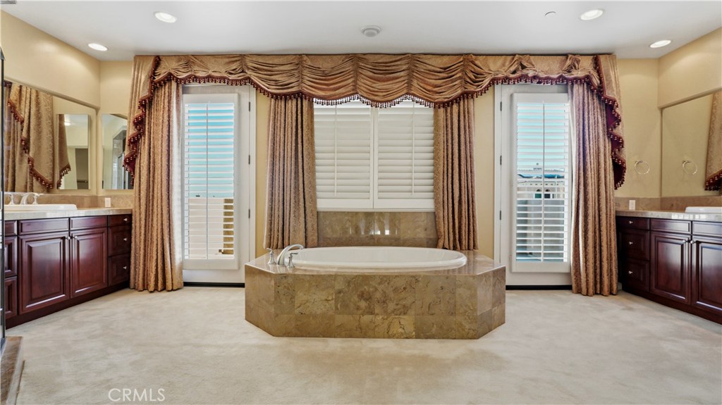 18549 Clydesdale Road Granada Hills, CA 91344 - Photo 39 of 56 a spacious bathroom with a tub shower and a sink