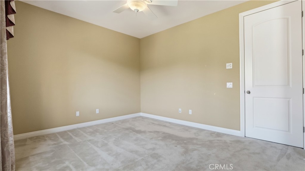 18549 Clydesdale Road Granada Hills, CA 91344 - Photo 45 of 56 an empty room with a chandelier fan