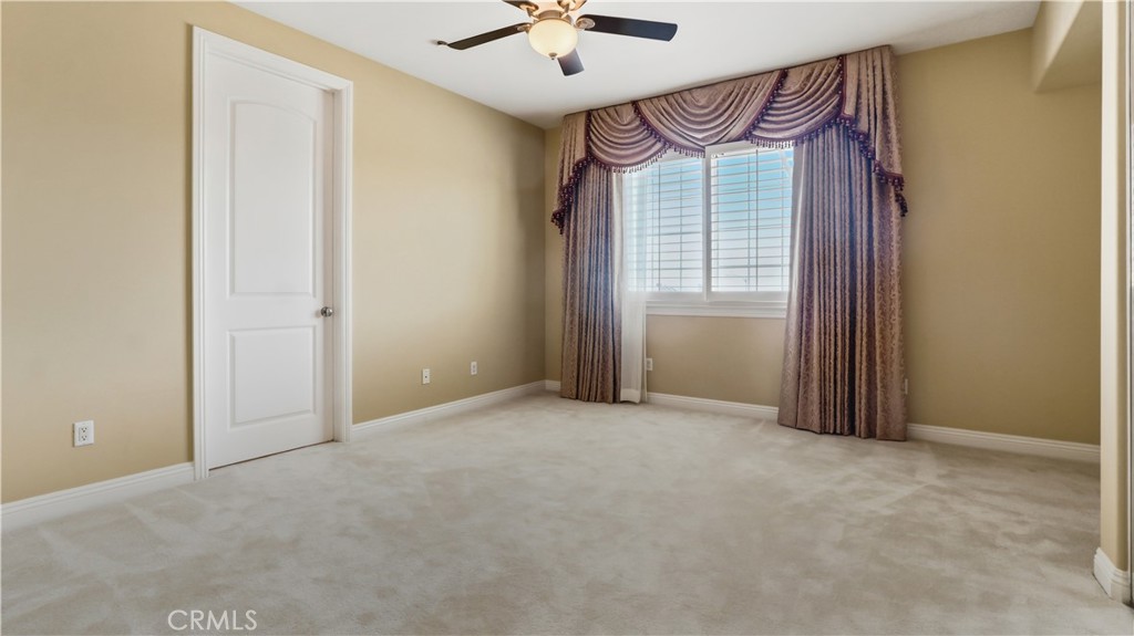 18549 Clydesdale Road Granada Hills, CA 91344 - Photo 46 of 56 an empty room with windows and fan