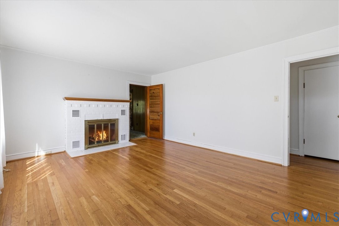 8100 Sandy Ridge Road Hopewell, VA 23860 - Photo 13 of 36 Living area featuring a white brick fireplace with