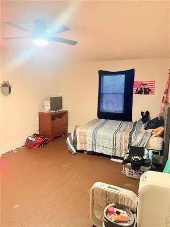 a bedroom with bed and a couch