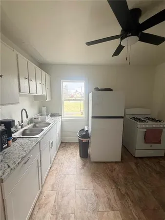 a kitchen with a sink and a stove top oven