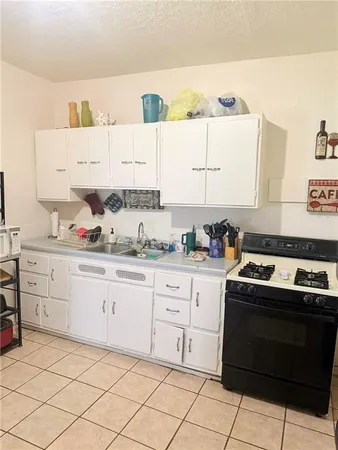a kitchen with granite countertop cabinets and window