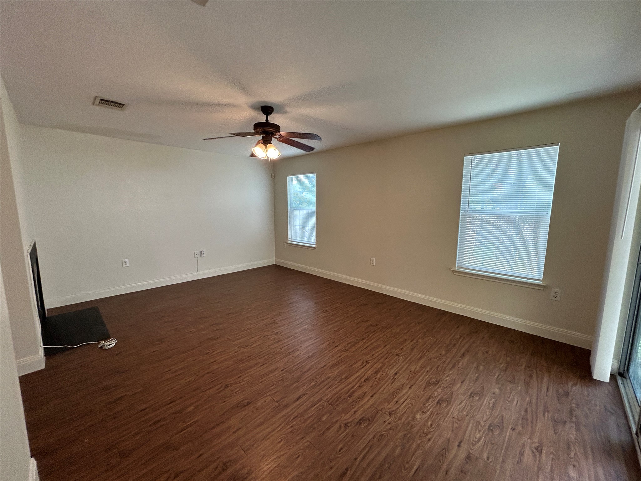 1909 Tranquilo Trail Austin, TX 78744 - Photo 5 of 14 Living room includes fireplace, natural light and a sliding glass door leading to covered patio.