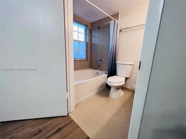 a bathroom with a toilet and a bathtub
