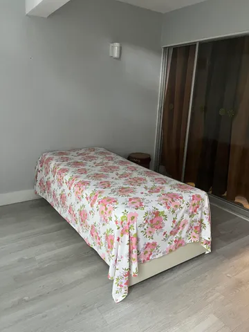 a bed sitting in a bedroom next to a wooden door