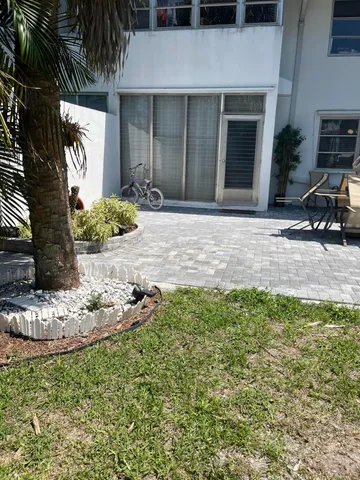 a big yard with lots of green space and trees in the background