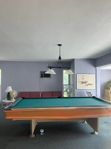 a swimming pool with outdoor seating and yard