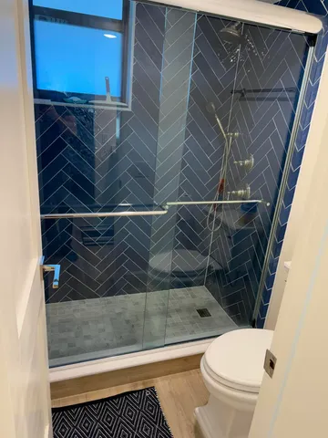 a bathroom with a toilet and a shower