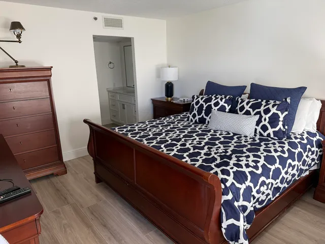 a large bed sitting in a bedroom next to a window