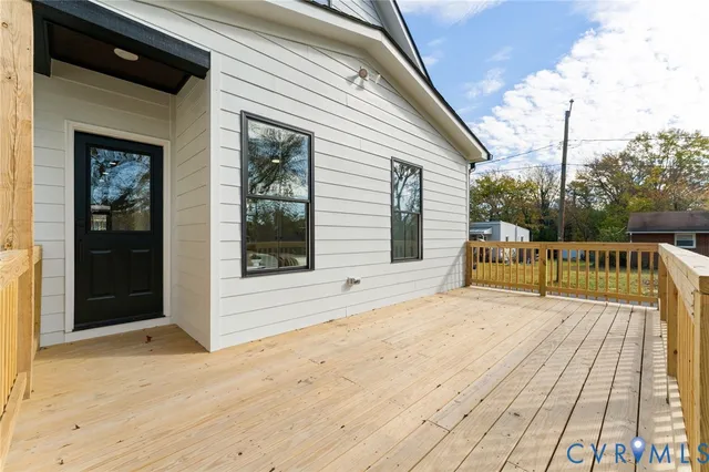 a view of a wooden deck with a yard