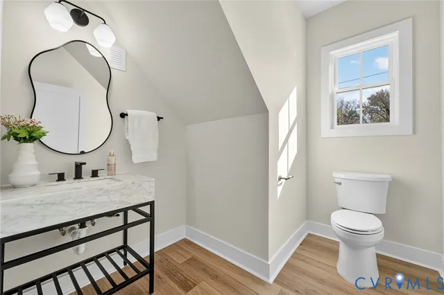a view of a hallway with wooden floor and closet