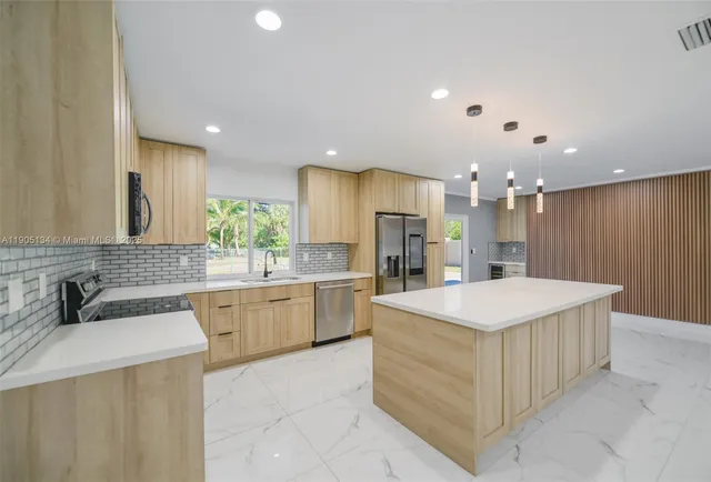 a view of an empty room with a fireplace and a window