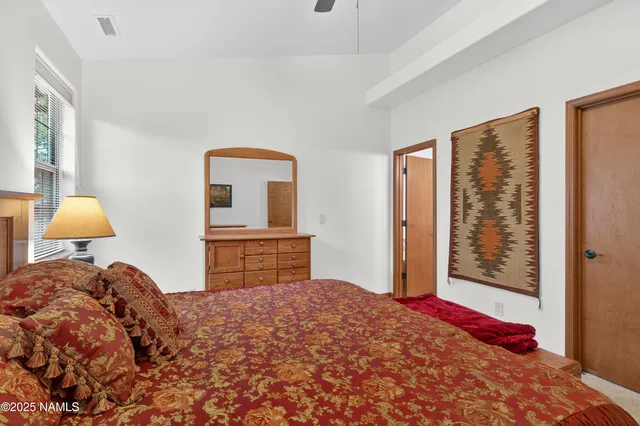 a bedroom with a large bed and dresser