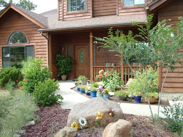 a view of a chair and a potted plant in front of a house