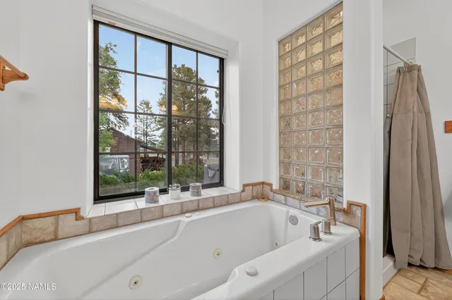a bathroom with a tub and sink