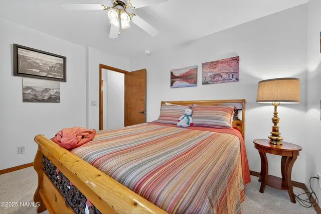 a bedroom with a bed and a lamp on dresser