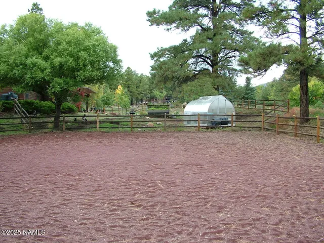 a backyard of house with trees and outdoor seating
