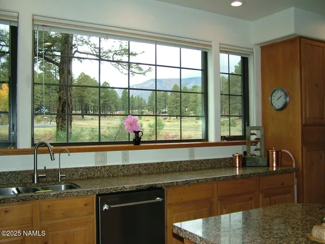 a kitchen with a sink and large window