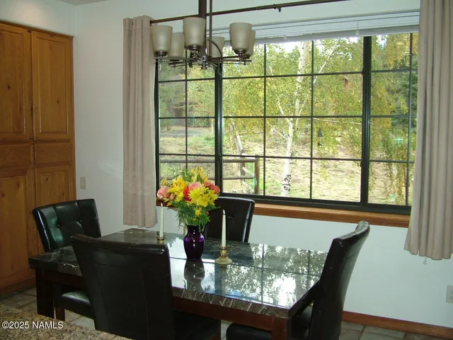 a dining room with furniture and window or chandelier